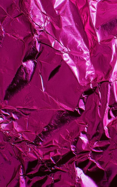 Magenta colored crumpled foil texture