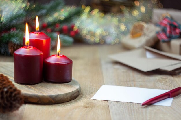 Magic Christmas three red burning candles next to a letter a Christmas tree and gifts