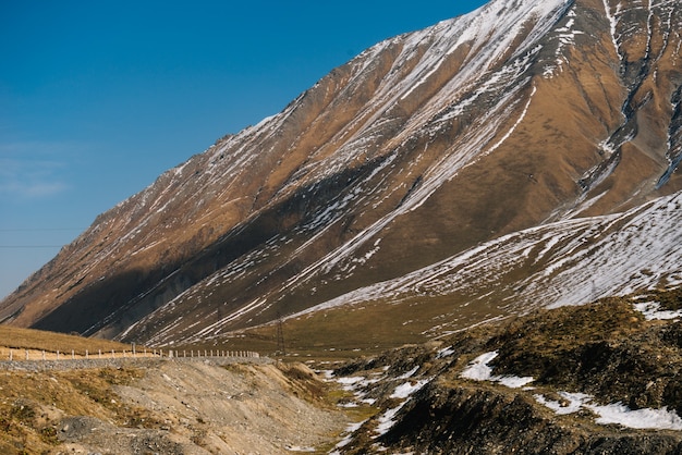 Magic enchanting nature, high mountains covered with white snow under a blue sky