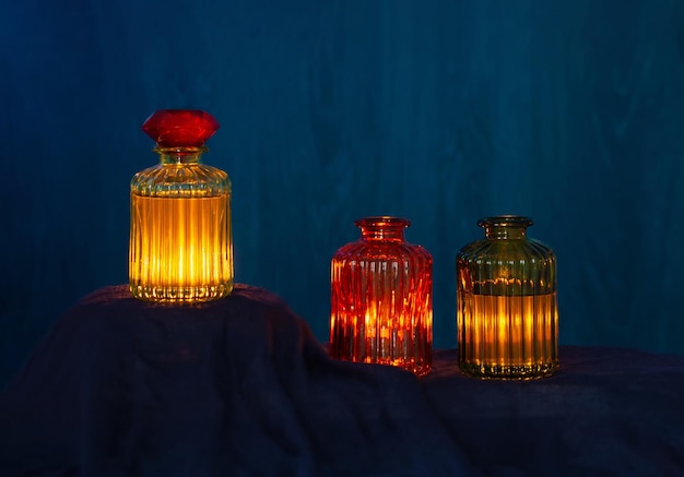 magic glowing potions in glass bottles on dark background