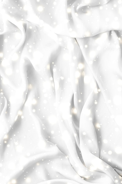 Magic holiday white soft silk flatlay background texture with glowing snow luxury beauty abstract backdrop