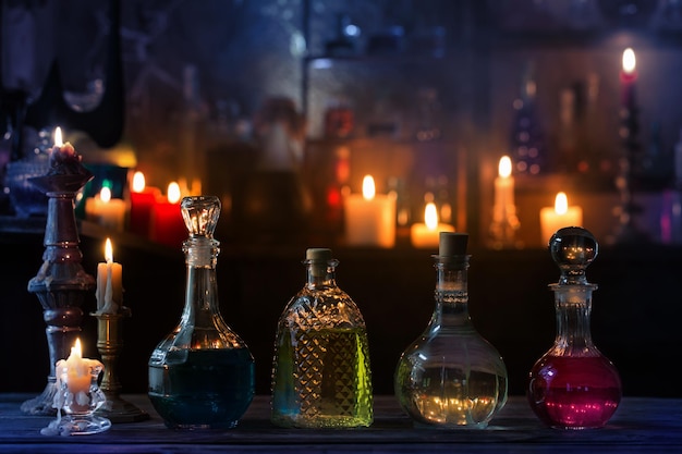 Magic potions in bottles on wooden background