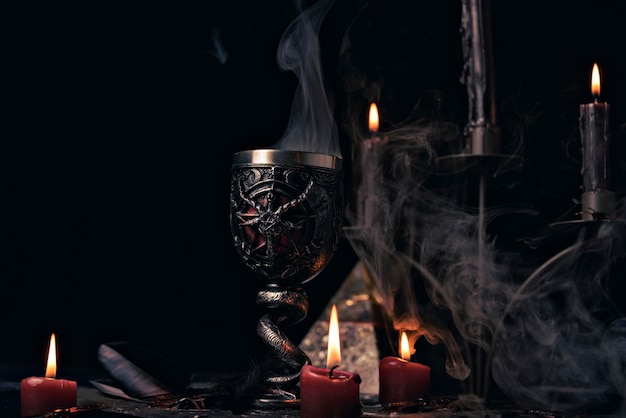 Magic potions in witch's house with burning candles at night