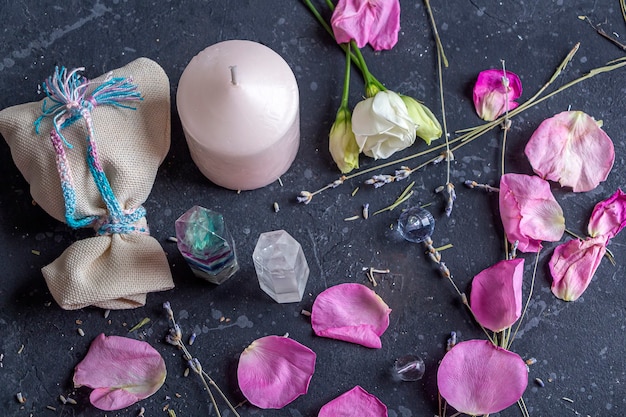 Magic still life with fluorite quartz crystal and pink candle.