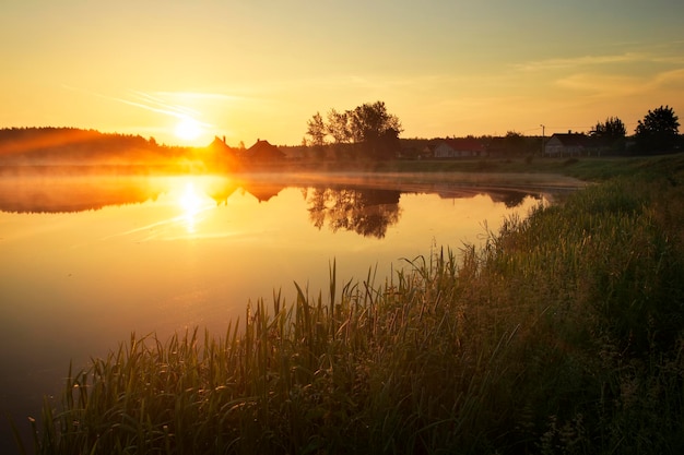 Magical sunset over the lake in the village Composition of Nature