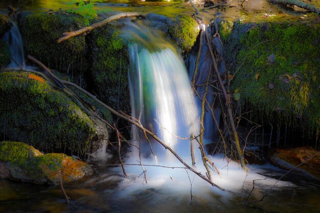 Magical waterfall falling into a river in Galicia Slow motion