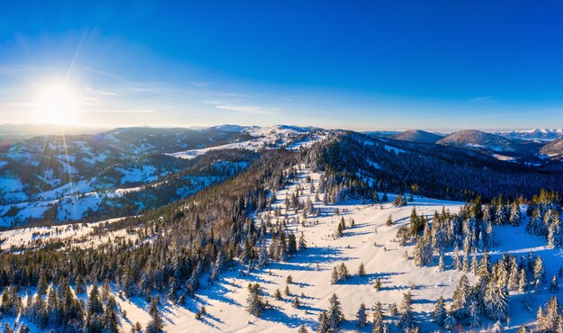 Magical winter panorama of beautiful snowy slopes at a ski resort in Europe on a sunny, windless frosty day. The concept of active recreation in winter