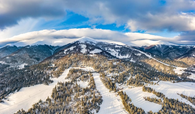 Magical winter panorama of beautiful snowy slopes at a ski resort in Europe on a sunny, windless frosty day. The concept of active recreation in winter