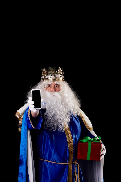 Magician using a mobile phone on a black background