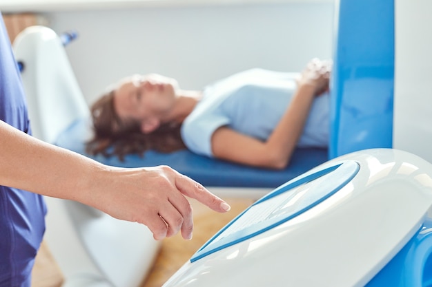 Magnet therapy system or Magnetic resonance imaging machine. Patient with doctor in a medical office.