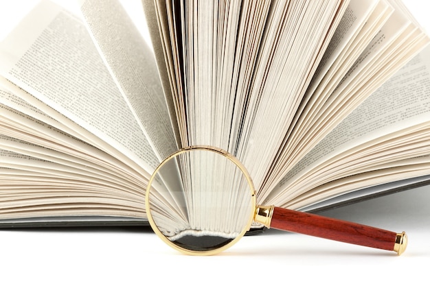 Magnifier and book closeup on the white