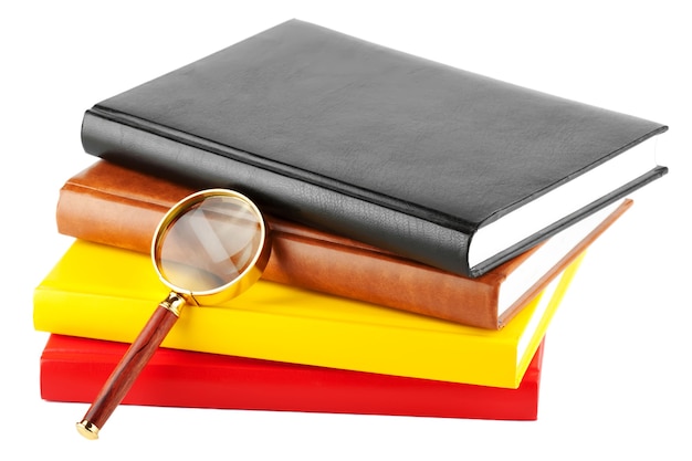 Magnifier and books closeup on the white background