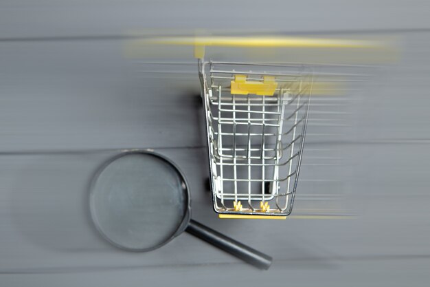 Magnifier and cart on gray wooden table