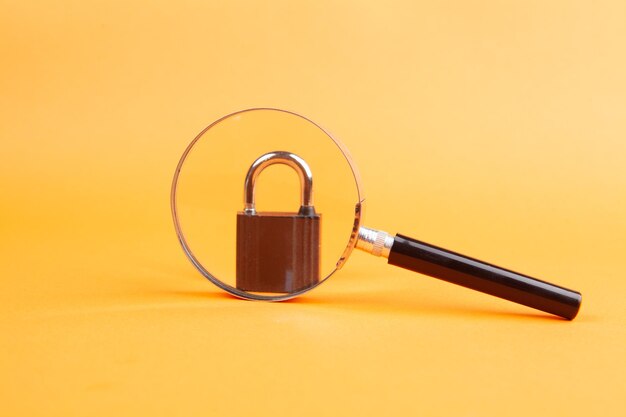 magnifier and lock on orange background