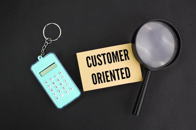 magnifying glass and calculator with customer oriented words customer conceptcustomer interaction