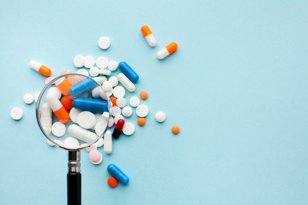 Magnifying glass and colourful pills