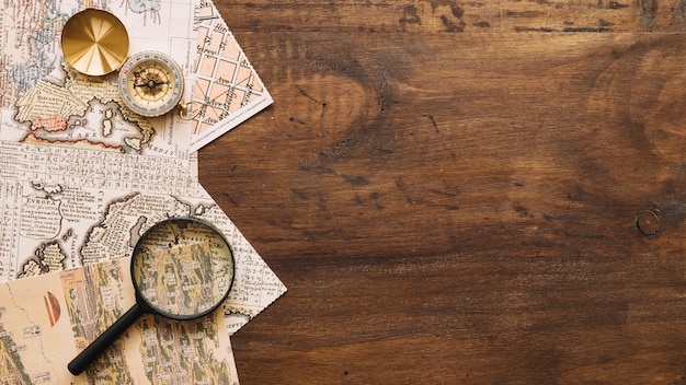 Magnifying glass and compass on maps