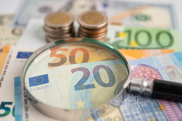 Magnifying glass and Euro banknotes background Banking Account Investment