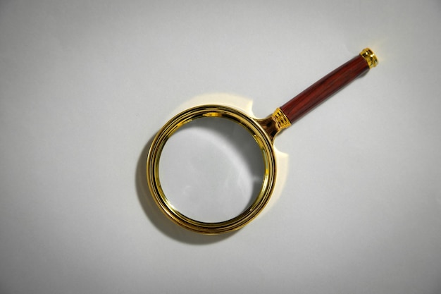 Magnifying glass on the grey background