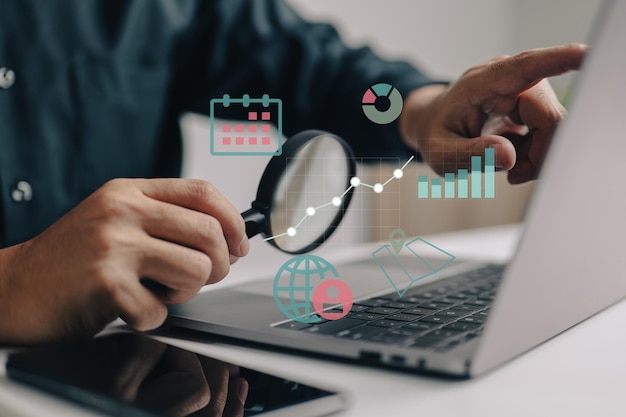 Magnifying glass in hand a smart business analyst examines graphs and charts while calculating or researching market expansion financial reports investment data or sales information concepts