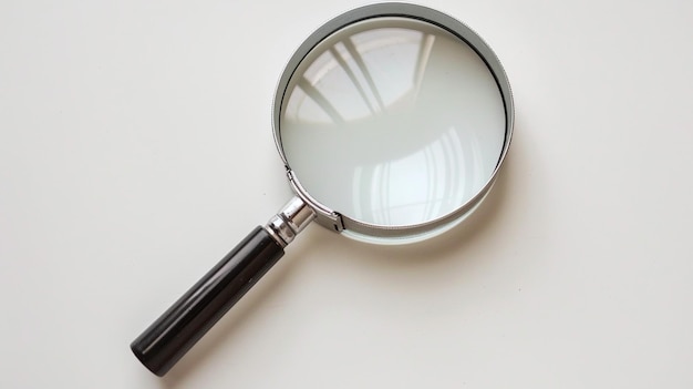 a magnifying glass is on a white surface