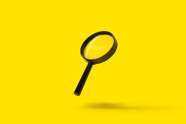 Magnifying glass loupe magnifier search flies soars over yellow surface.