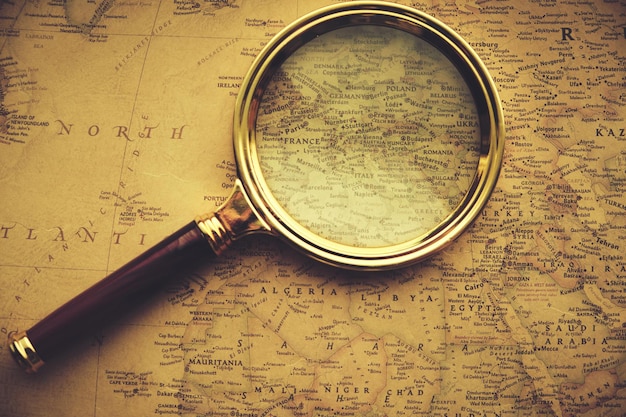 Magnifying glass on the old map with Europe.