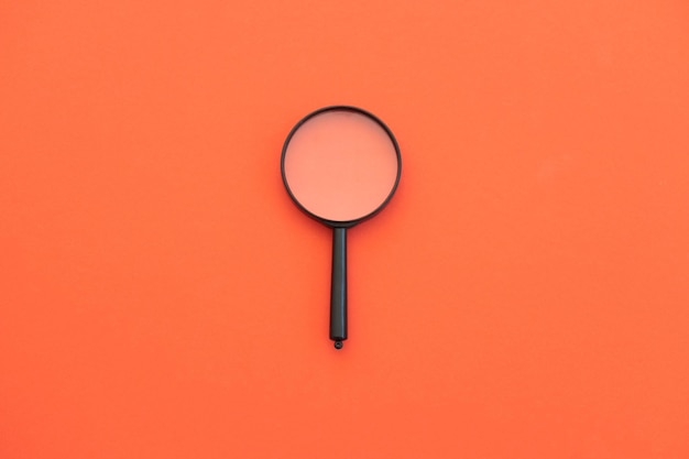 Magnifying glass on red background