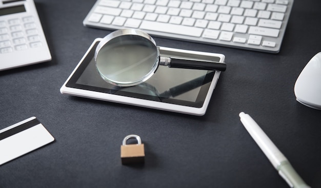 Magnifying glass on the tablet computer.