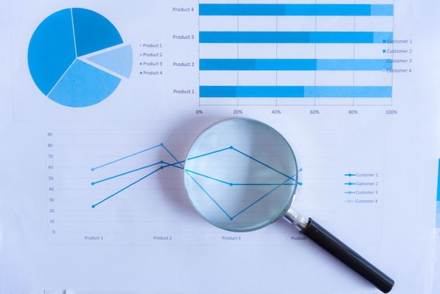 Magnifying glass with paper graph.Analysis concepts