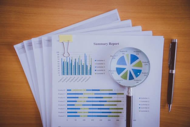 Magnifying glass with paper graph.Analysis concepts