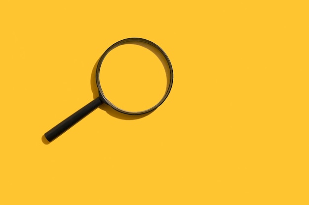 Magnifying glass on a yellow background