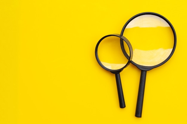 Magnifying glasses on yellow