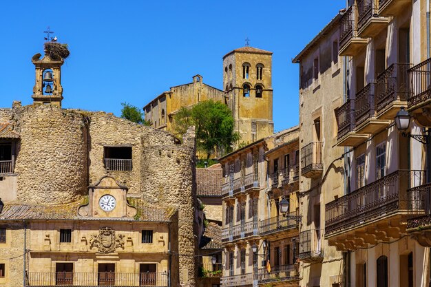 Main square of the medieval town of Sepulveda with the Town Hall building and a stork's nest above it