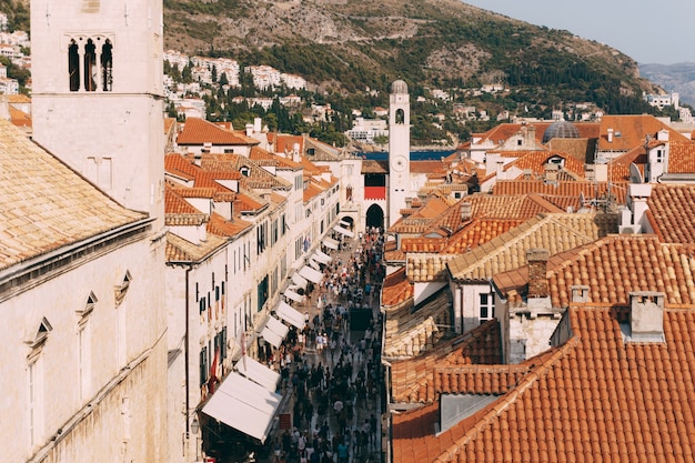 Main street stradun in the old town of dubrovnik tourists walk around the city tiled roofs of