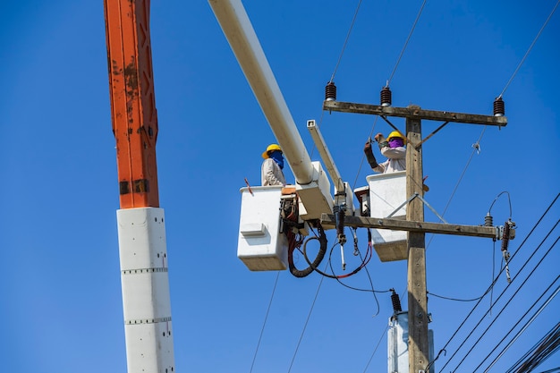 Maintenance of electricians work with high voltage electricity on the hydraulic bucket