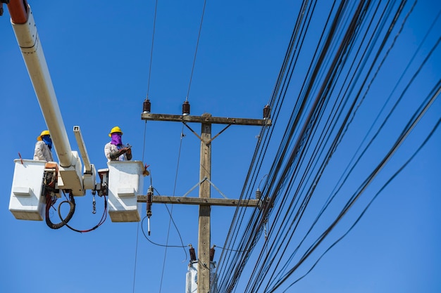 Maintenance of electricians work with high voltage electricity on the hydraulic bucket