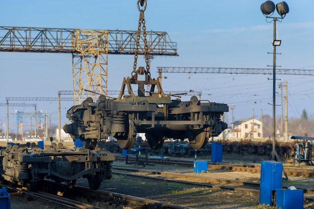 Maintenance in railway main depot with industrial crane that raises the driving wheels for train