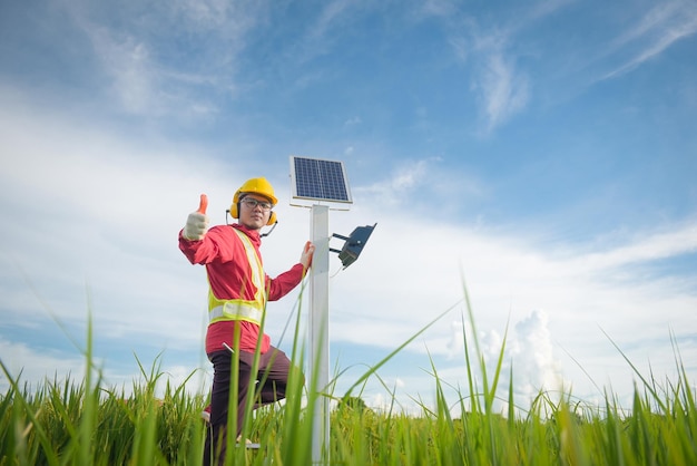 Maintenance technician during installation of solar photovoltaic panels in farmland