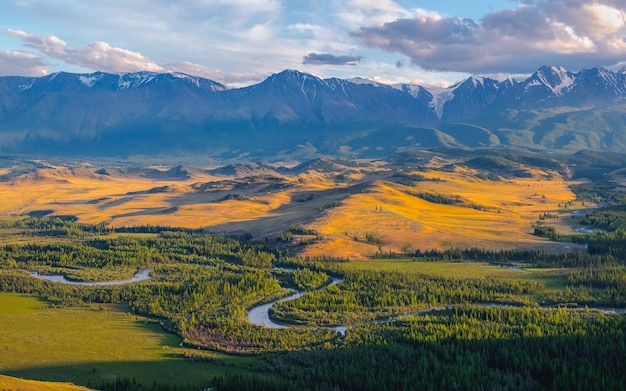 Majestic autumn mountain landscape Panoramic landscape with a winding river through a coniferous forest and mountains in a light fog Altai Mountains