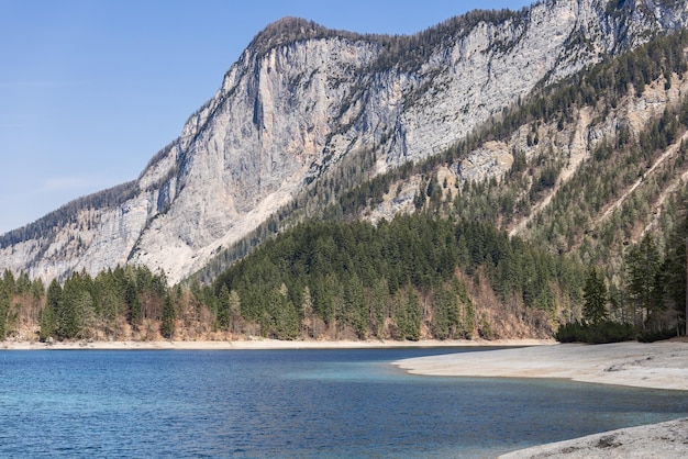 Majestic forested peaks of the Brenta Dolomites and Lake Tovel. Ville d'Anaunia, Trentino, Italy