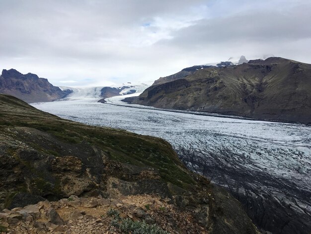 Majestic glacier in hofn southern iceland in a cloudy day with contrast of mountains and ice