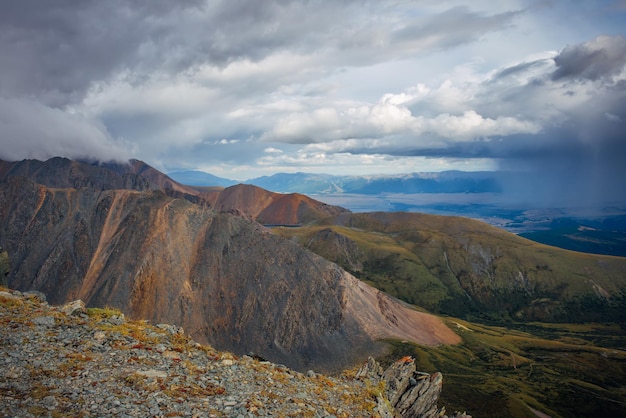 Majestic mountain landscape opening from a viewing point Panorama of mountain peaks and stormy sky