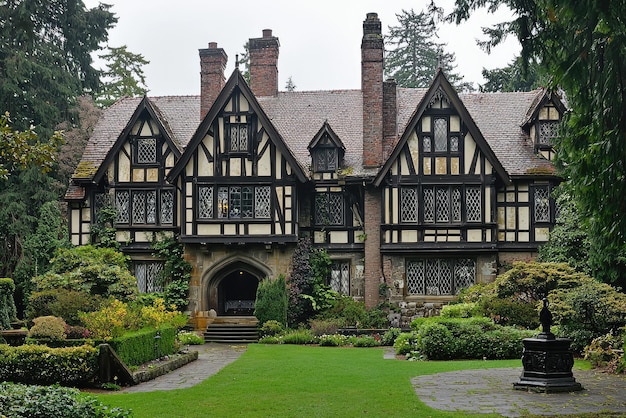 Majestic Tudor mansion with steep pitched roof and intricate timber framework surrounded by lush garden landscape and historic charm