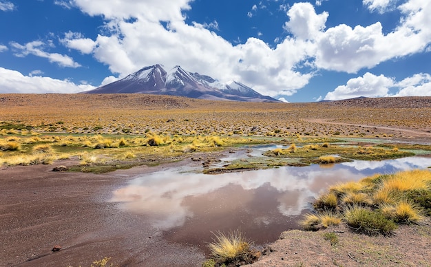 Majestic view of Volcano and clouds reflecting in water in Bolivia South America