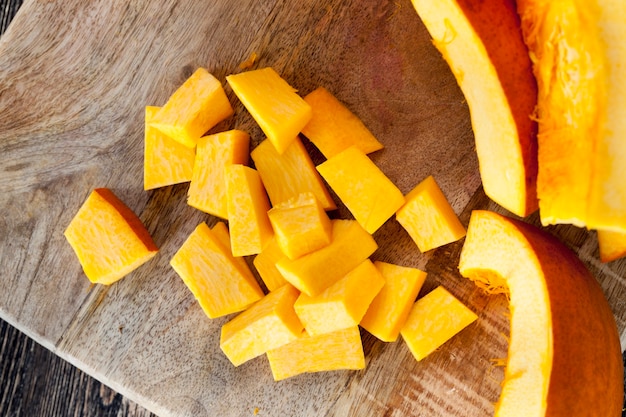 Make an orange pumpkin soft tasty sliced, close-up of raw food