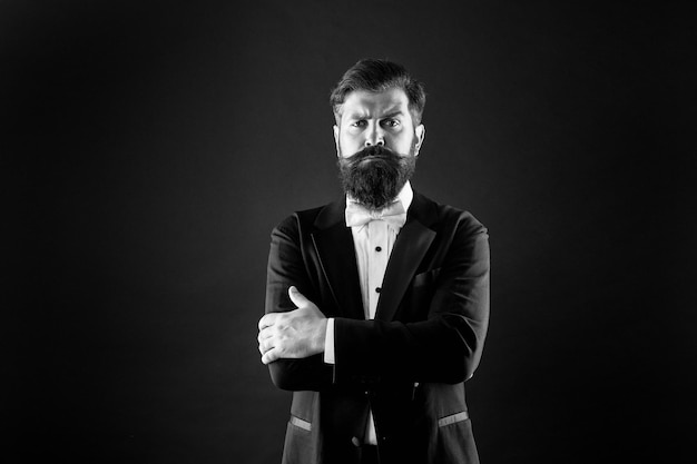 Make statement Confident man black background Bearded man keep arms crossed with confidence Confident look of fashion hipster Classy tuxedo makes him feel confident Confident at every occasion