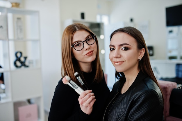 Make up artist work in her beauty visage studio salon Woman applying by professional make up master Beauty club concept