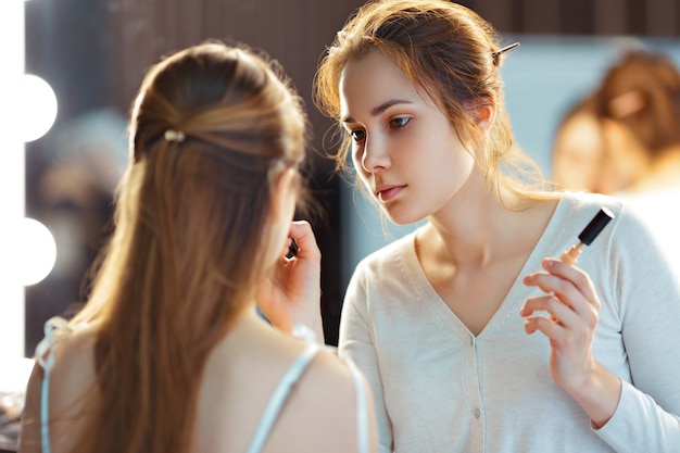 Makeup artist applying consealer