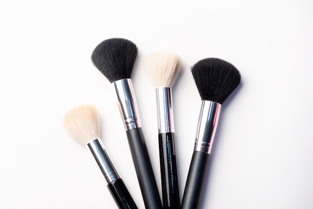 Makeup brush and blush on a white background. Beauty concept. Close-up with space for text